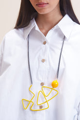 Long yellow statement necklace with geometric design.